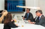 Mixed Group In Business Meeting Seen Through Glass Door Stock Photo