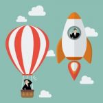 Businessman On A Rocket Fly Pass Businessman In Hot Air Balloon Stock Photo