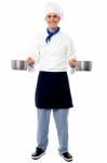 Young Male Chef Holding Empty Vessels Stock Photo