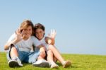 Smiling young kids waving hands Stock Photo