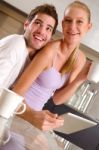 Couple In Kitchen Having Breakfast Stock Photo