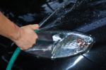 Man Cleaning Car With Water Stock Photo