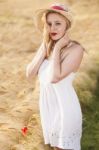 Lonely Beautiful Young Blonde Girl In White Dress With Straw Hat Stock Photo