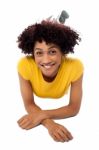 Woman In Yellow Top Relaxing On Studio Floor Stock Photo