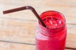 Iced Drink In Red Glass On Wooden Table Stock Photo