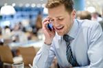 Business Man Talks On Mobile In Cafe Stock Photo