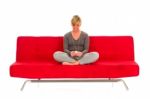 Woman Sat On Red Sofa  Stock Photo