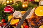 Christmas Baked Duck Served With Potatoes, Orange And Tomatoes Stock Photo