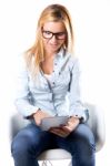 Beautiful Young Woman Sitting At Home With Digital Tablet Stock Photo