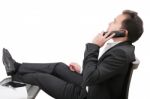 Young Business Man Relaxing At Office Desk And Talking On Mobile Stock Photo