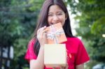 Portrait Of Thai Teen Beautiful Girl In Chinese Dress, Happy New Year And Open Box Gift, Smile And Very Happy Stock Photo