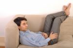 Man Sleeping On The Couch Stock Photo