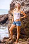 Beautiful Young Blonde Woman Posing Outdoor At The Rocky Sea Sho Stock Photo