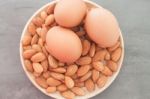 Almond Nuts And Eggs On Wooden Plate Stock Photo