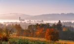 Tower Of Rural Church In Misty Autumn Morning Stock Photo