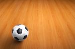 Football On Wooden Floor Stock Photo