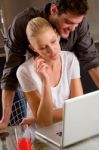 Couple At Home Using Laptop Stock Photo