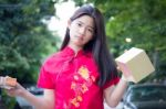 Portrait Of Thai Teen Beautiful Girl In Chinese Dress, Happy New Year And Open Box Gift, Smile And Very Happy Stock Photo