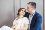 Couple Of Newlyweds Are Sitting Together Looking At Each Other Stock Photo