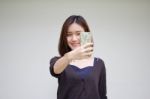 Portrait Of Thai Adult Student University Beautiful Girl Using Her Smart Phone Selfie Stock Photo