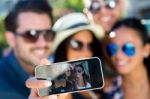 Portrait Of Group Friends Taking Photos With A Smartphone Stock Photo