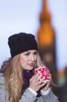 Attractive Young Stylish Blonde Girl Drinks Hot Drink From A Mug Stock Photo