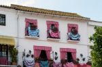 Traditional Spanish Dresses Adorning Balconies On A Building In Stock Photo