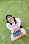 Lovely Girl With A Laptop On The Grass Stock Photo