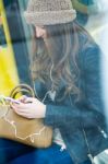 Young Woman With Her Mobile Phone While Waiting For The City Bus Stock Photo