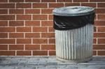 Bin And Brick Wall Stock Photo