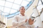 Good Looking Young Businessman With Tablet Computer In Modern Bu Stock Photo