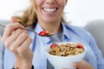 Beautiful Young Woman Eating Cereals At Home Stock Photo