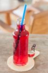 Red Syrup In The Bottle On Wooden Plate Stock Photo