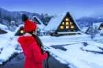 Young Woman In Shirakawa-go Village In Winter, Unesco World Heritage Sites, Japan Stock Photo