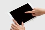 Finger Being Pointed On Tablet Screen Stock Photo