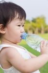 Little Asian Girl  Drinking Water From Plastic Bottle Stock Photo