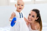 Baby Girl And Her Mother Playing At Home Stock Photo