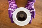 Gloved Hands Holding Cup Of Coffee Stock Photo