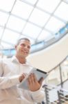 Smiling Man In White Shirt With Tablet Computer In Modern Busine Stock Photo