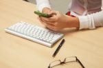 Women With Cell Phone In Office Stock Photo