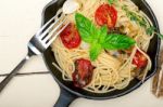 Spaghetti Pasta With Baked Cherry Tomatoes And Basil Stock Photo