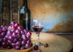 Wine And Grapes On A Wooden Stock Photo