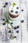 Glass Of Yogurt With Fresh Blueberries Stock Photo