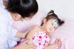 Sick Little Girl Nursed By A Pediatrician Stock Photo