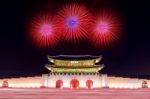 Geyongbokgung Palace At Night With Firework And Car Light In Seoul, South Korea Stock Photo