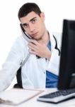 Male Doctor Speaking Over Telephone Stock Photo