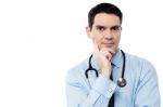 Pensive Physician Looking At Camera Stock Photo