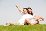 Young Couple Sitting Together Stock Photo