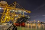 Container Cargo Freight Ship With Working Crane Loading Stock Photo