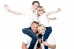 Playful Family Of Four Isolated Over White Stock Photo